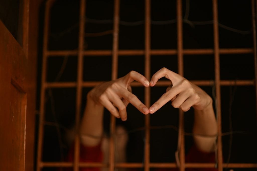 persons hand on brown metal frame